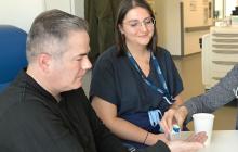 Dr. Rahima Jamal and Camille Amiel prepare the patient to take the fecal microbiota capsules. Photo: Centre hospitalier de l’Université de Montréal (CHUM)